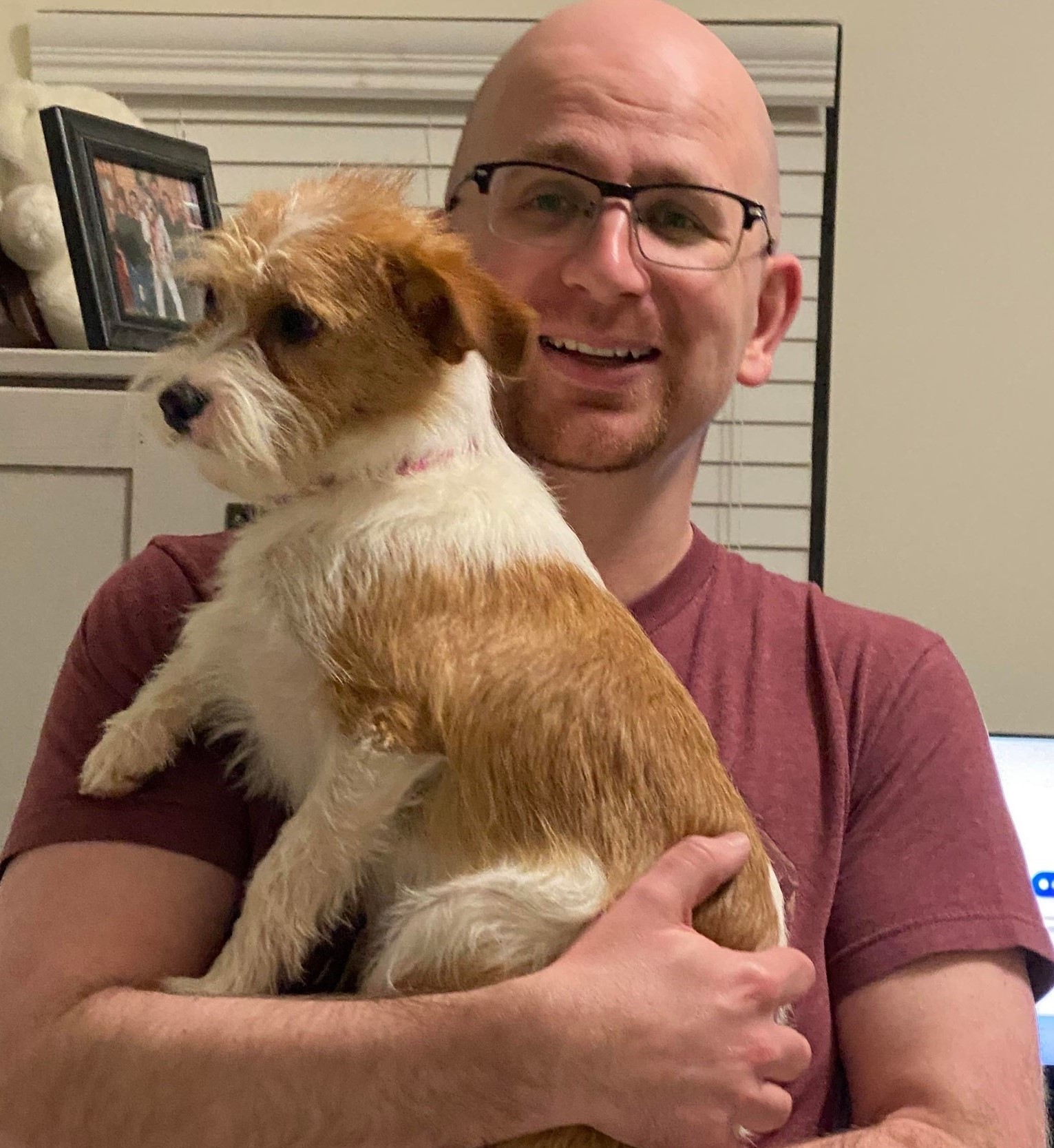 Photo of Ben Wright holding a small dog.