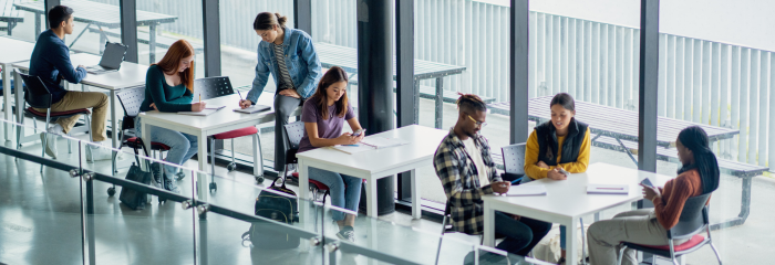 Graduate students in working in bright modern student center.